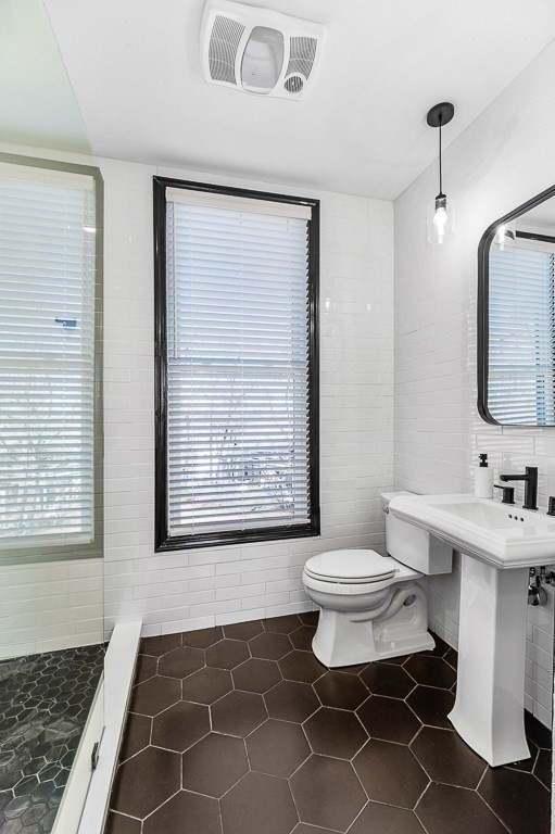 5 Babson Street, Unit 2 Gloucester, MA 01930 - Photo 21 of 30 a bathroom with a sink toilet a mirror and vanity