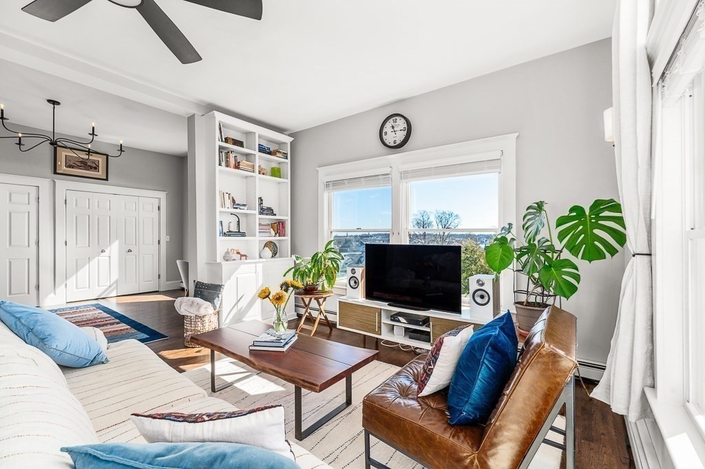 5 Babson Street, Unit 2 Gloucester, MA 01930 - Photo 6 of 30 a living room with furniture a flat screen tv and a large window