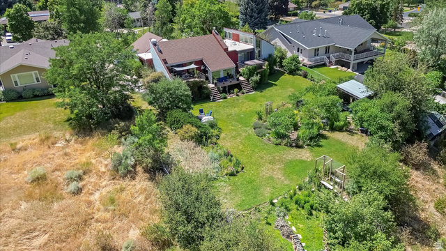 510 Spring Creek Road Providence, UT 84332 - Photo 62 of 97 Tiered landscaping with expansive green lawn, mature trees, and established garden beds
