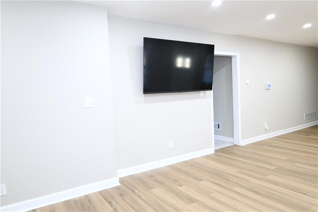1876 Sandtown Road Southwest Atlanta, GA 30311 - Photo 8 of 20 a view of a livingroom with wooden floor and a flat screen tv