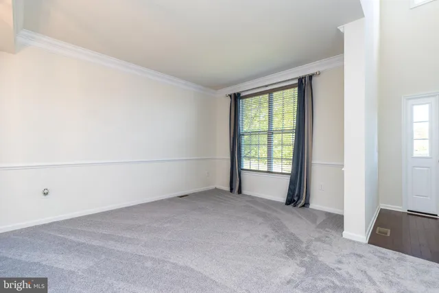 a kitchen with granite countertop white cabinets and stainless steel appliances