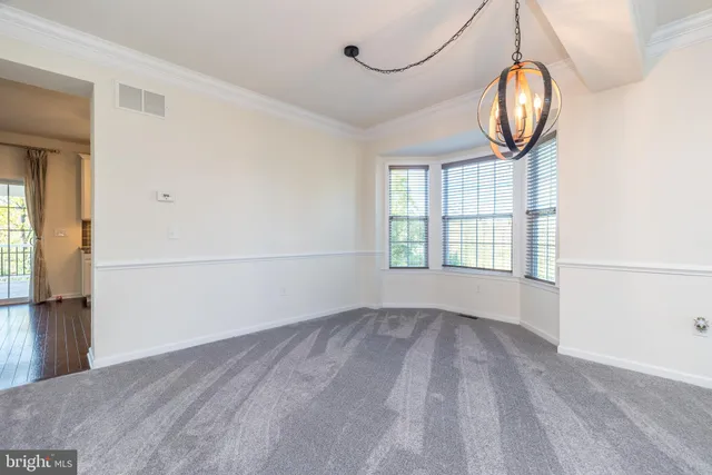 a kitchen with stainless steel appliances granite countertop a refrigerator a sink dishwasher a stove and white cabinets with wooden floor