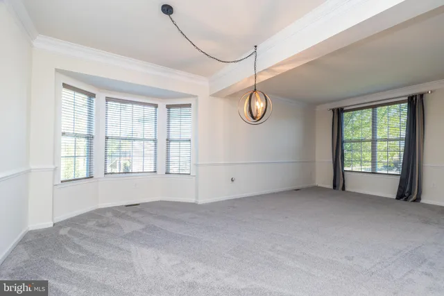 an empty room with wooden floor and fireplace