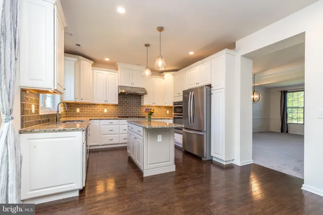 a view of entryway with wooden floor and stairs