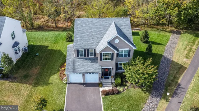 a view of a house with a yard and sitting area