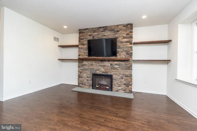 a view of an empty room and wooden floor