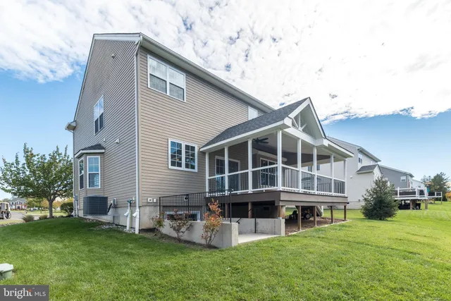 a view of a yard with brick walls and a large tree