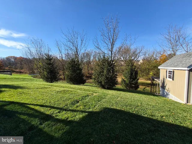 an aerial view of a house with garden space and street view