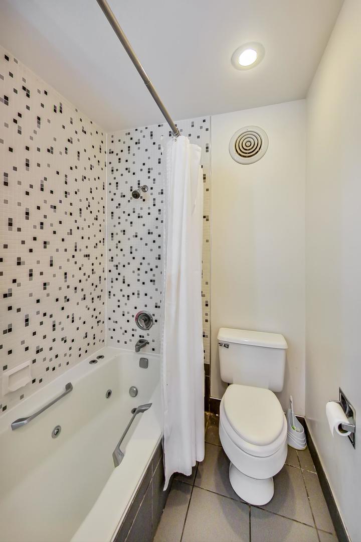 331 South Peoria Street, Unit 502 Chicago, IL 60607 - Photo 12 of 32 a bathroom with a toilet and a shower