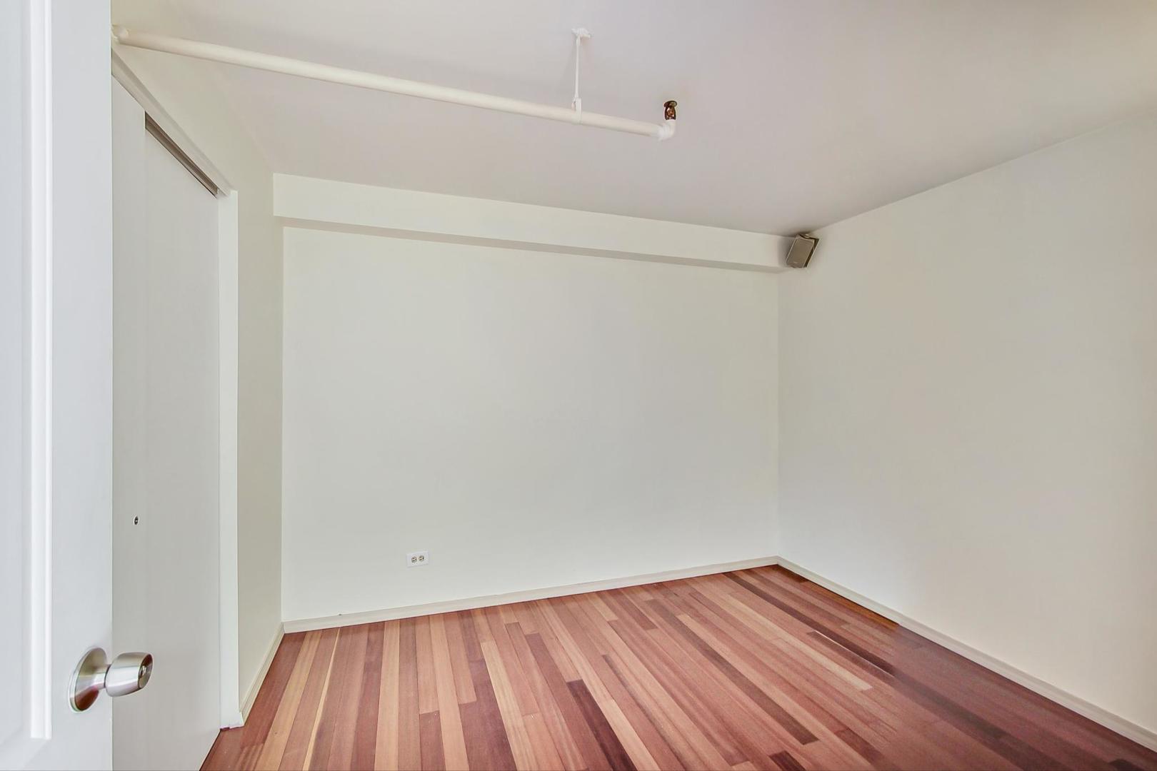 331 South Peoria Street, Unit 502 Chicago, IL 60607 - Photo 20 of 32 a view of a room with wooden floor