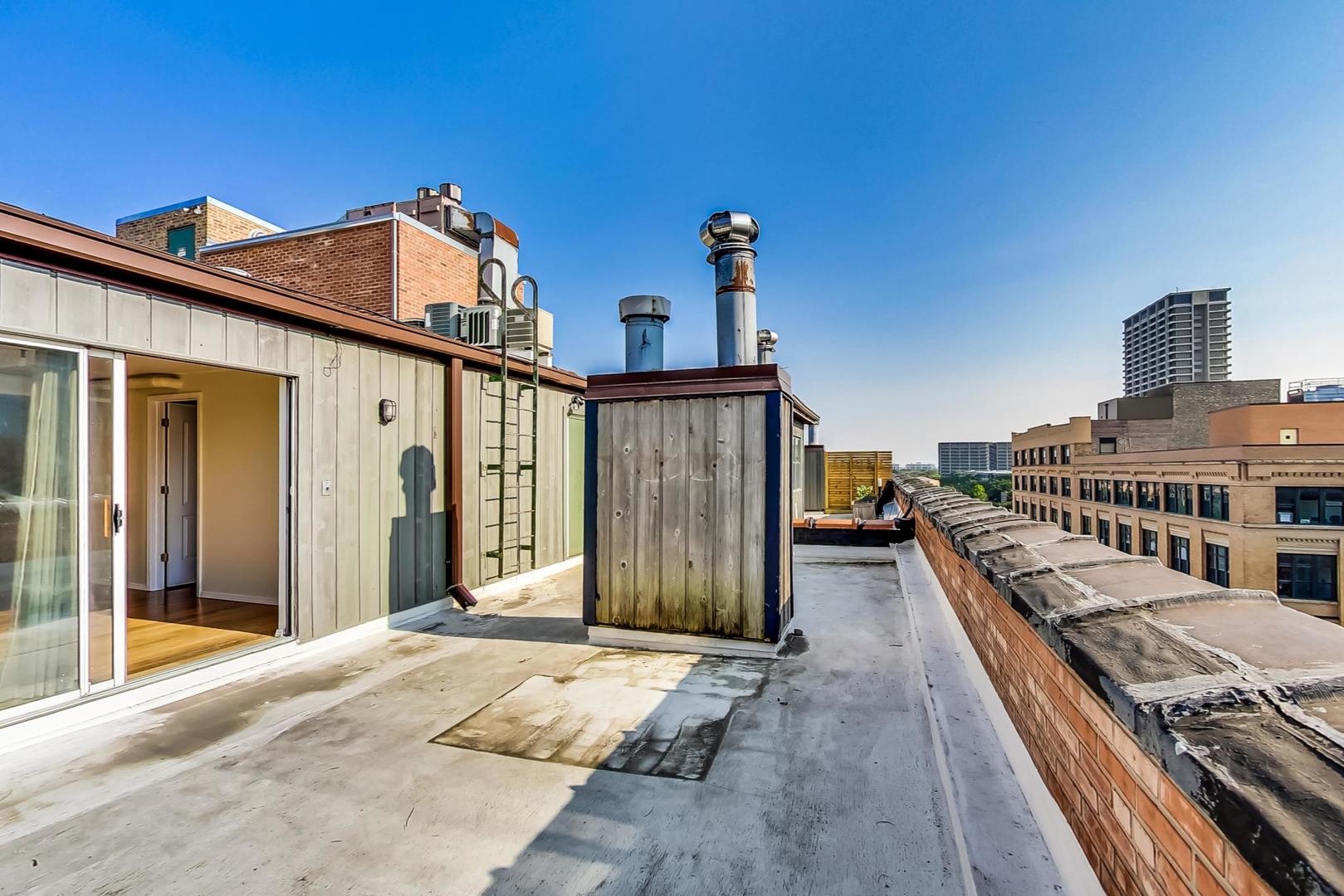 331 South Peoria Street, Unit 502 Chicago, IL 60607 - Photo 24 of 32 a view of a house with many windows