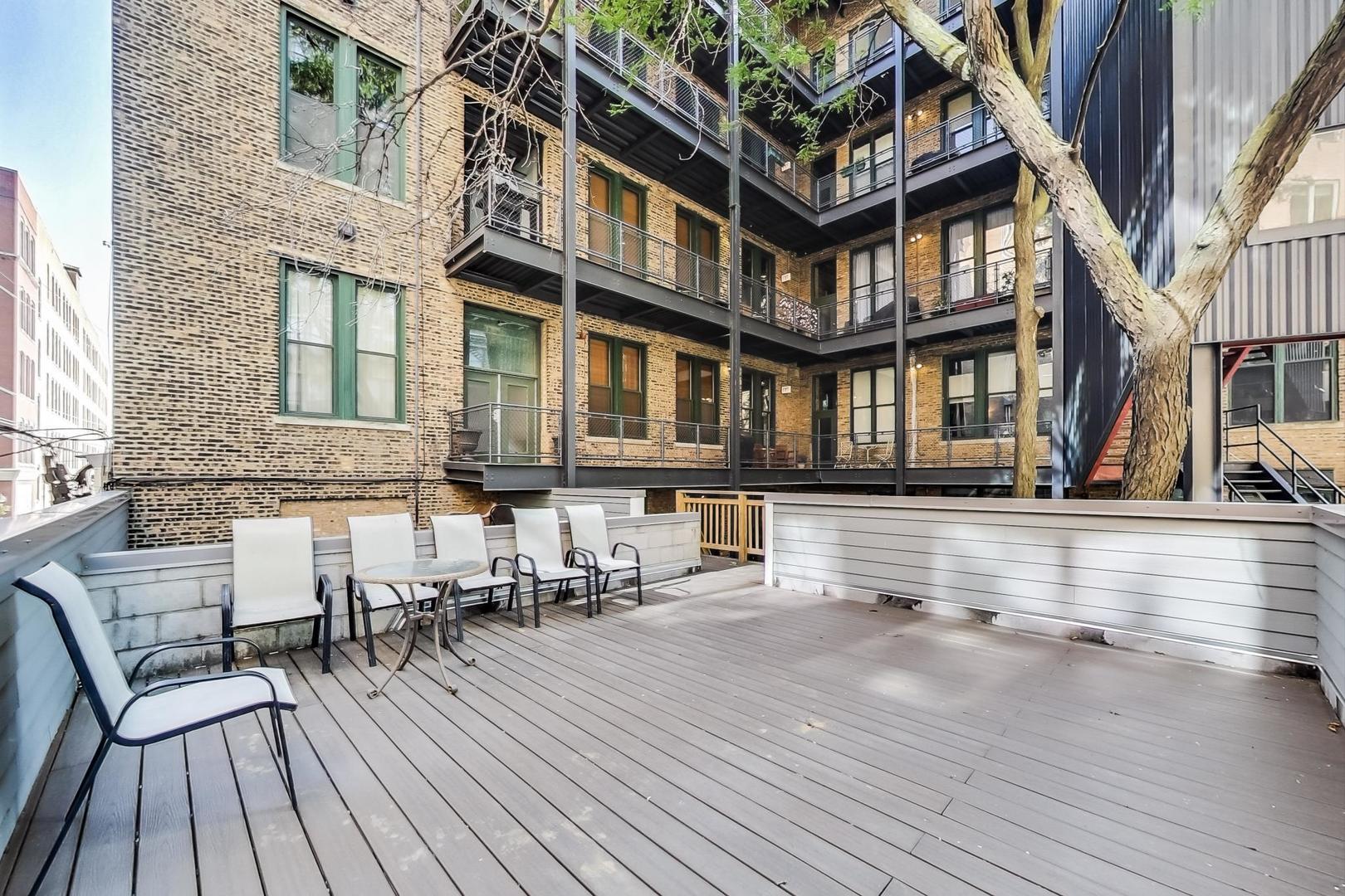 331 South Peoria Street, Unit 502 Chicago, IL 60607 - Photo 32 of 32 front view of a building with a bench