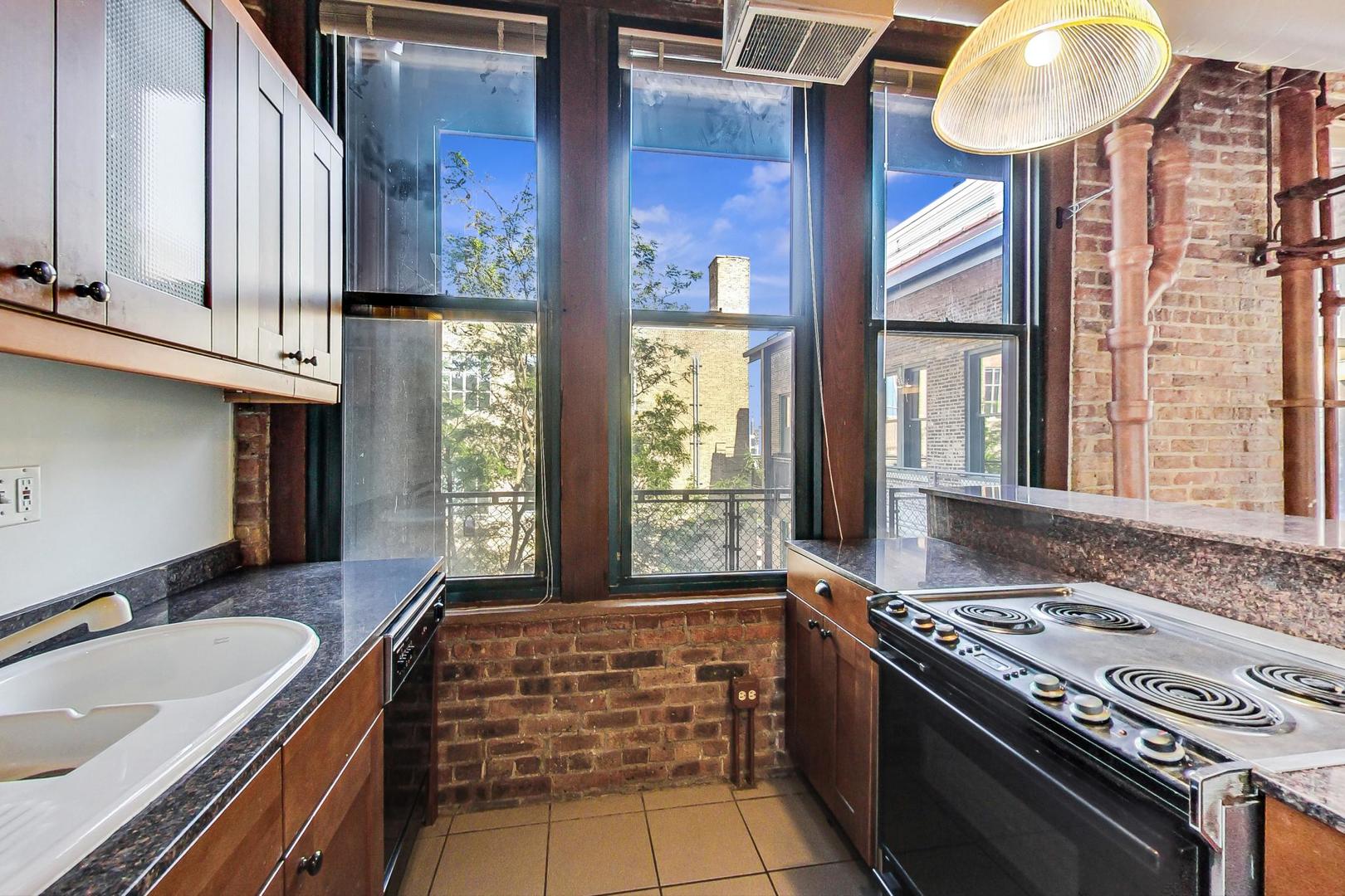 331 South Peoria Street, Unit 502 Chicago, IL 60607 - Photo 7 of 32 a kitchen with a stove and a sink