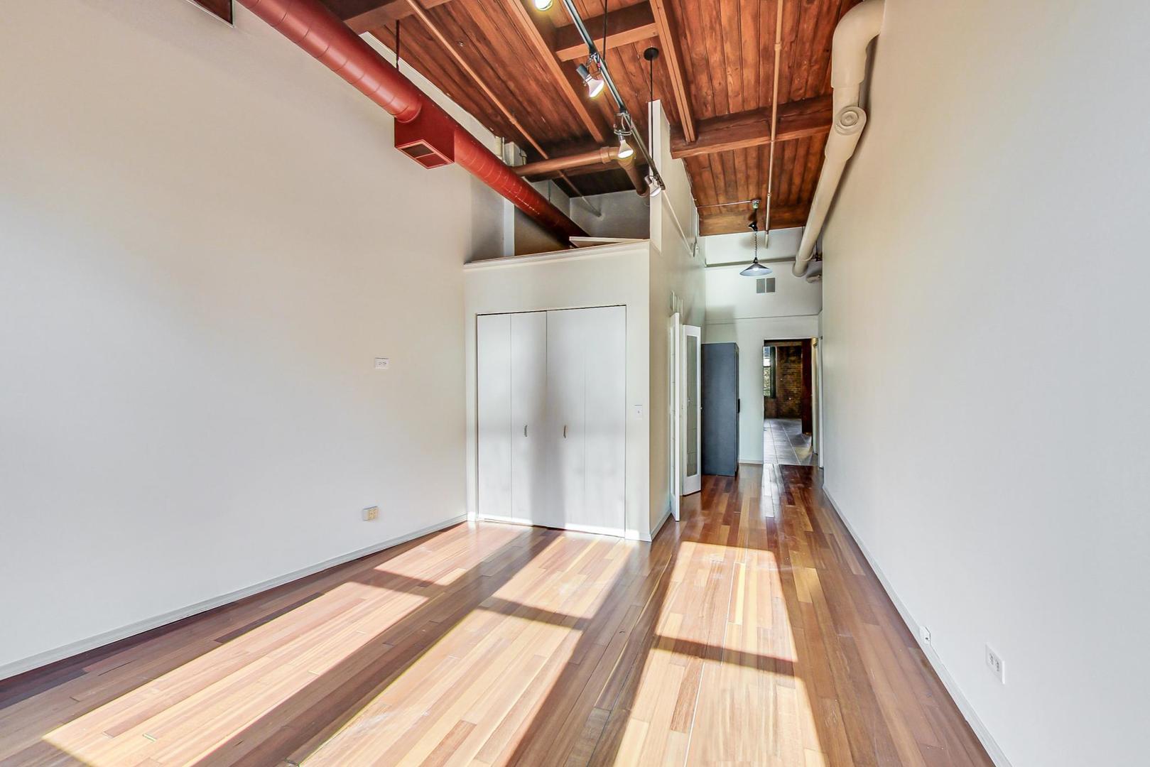331 South Peoria Street, Unit 502 Chicago, IL 60607 - Photo 9 of 32 a view of a room with wooden floor and staircase