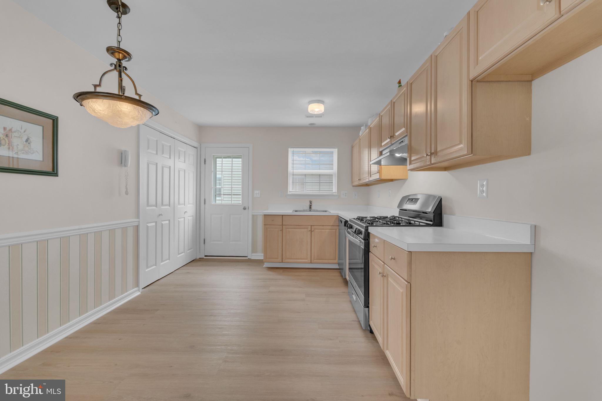 801 Freeport Way Williamstown, NJ 08094 - Photo 17 of 29 a kitchen with stainless steel appliances granite countertop a refrigerator a stove a sink dishwasher and white cabinets with wooden floor