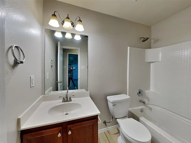 a white toilet sitting next to a bath tub