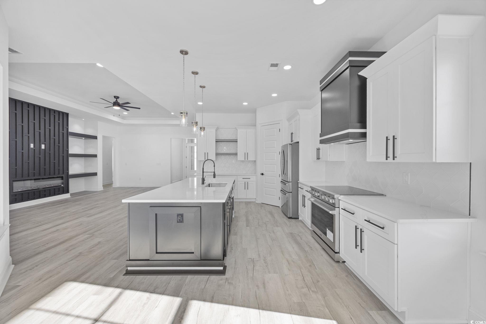 125 Lac Courte Myrtle Beach, SC 29579 - Photo 40 of 40 Kitchen featuring pendant lighting, stainless steel appliances, white cabinetry, light wood finished floors, and open floor plan