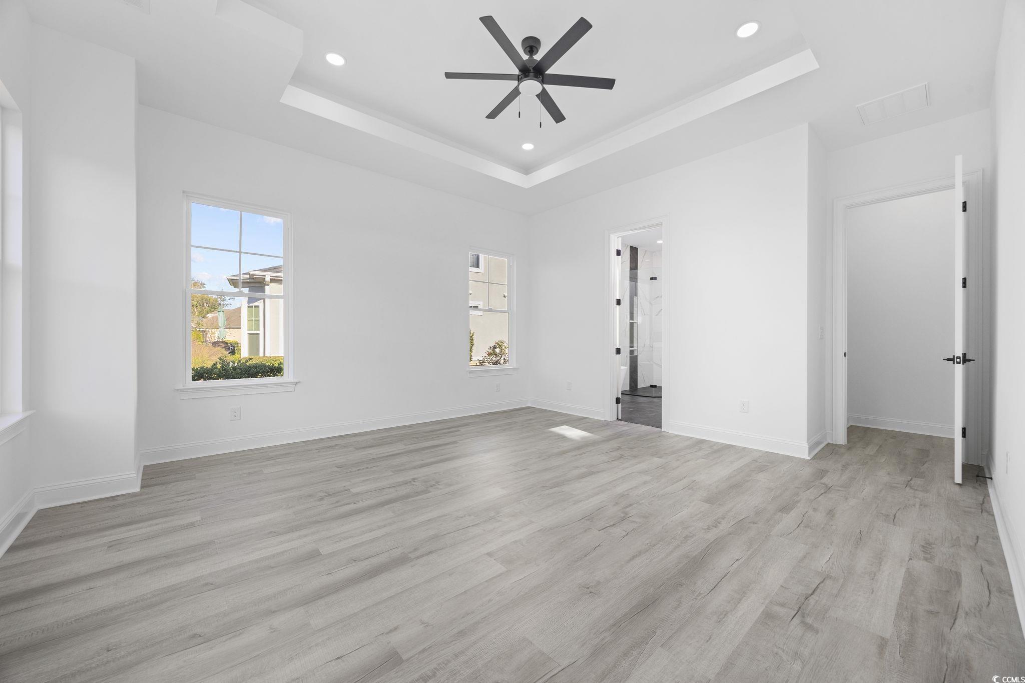 125 Lac Courte Myrtle Beach, SC 29579 - Photo 22 of 40 Spare room featuring a raised ceiling, light wood finished floors, recessed lighting, and ceiling fan