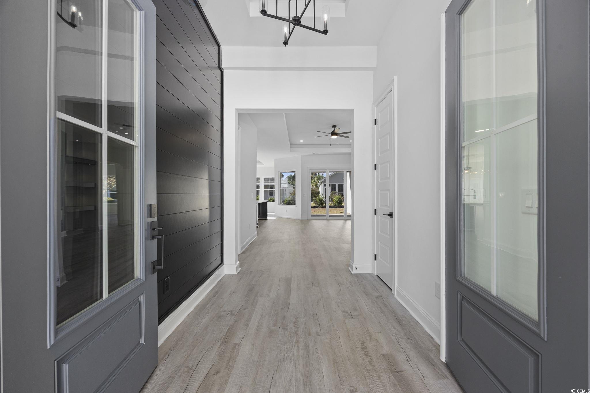 125 Lac Courte Myrtle Beach, SC 29579 - Photo 3 of 40 Corridor with light wood-type flooring and a chandelier
