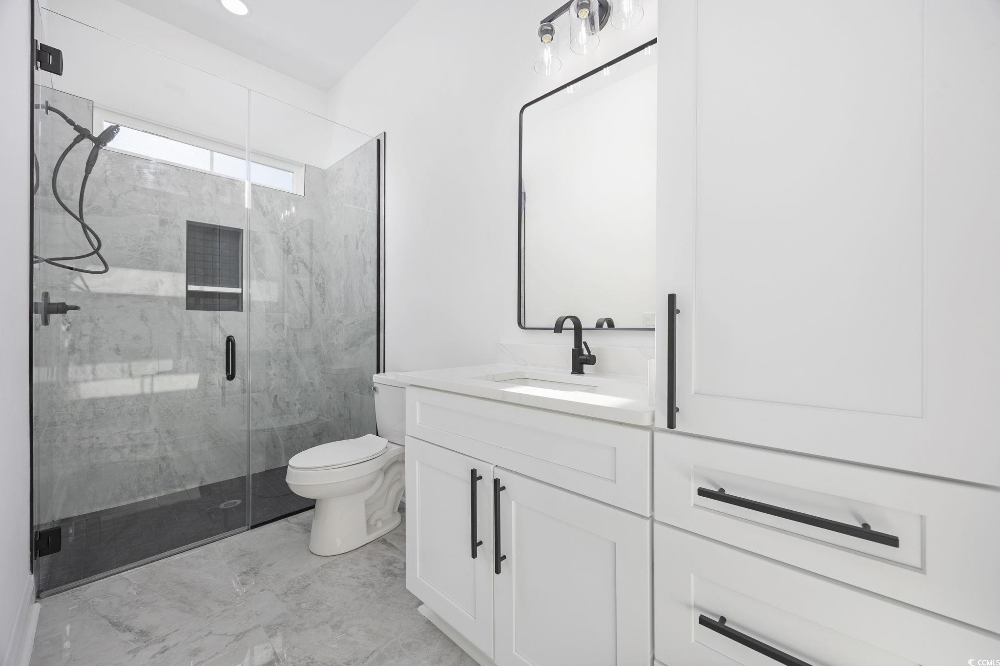 125 Lac Courte Myrtle Beach, SC 29579 - Photo 30 of 40 Bathroom with vanity, a marble finish shower, and light marble finish flooring