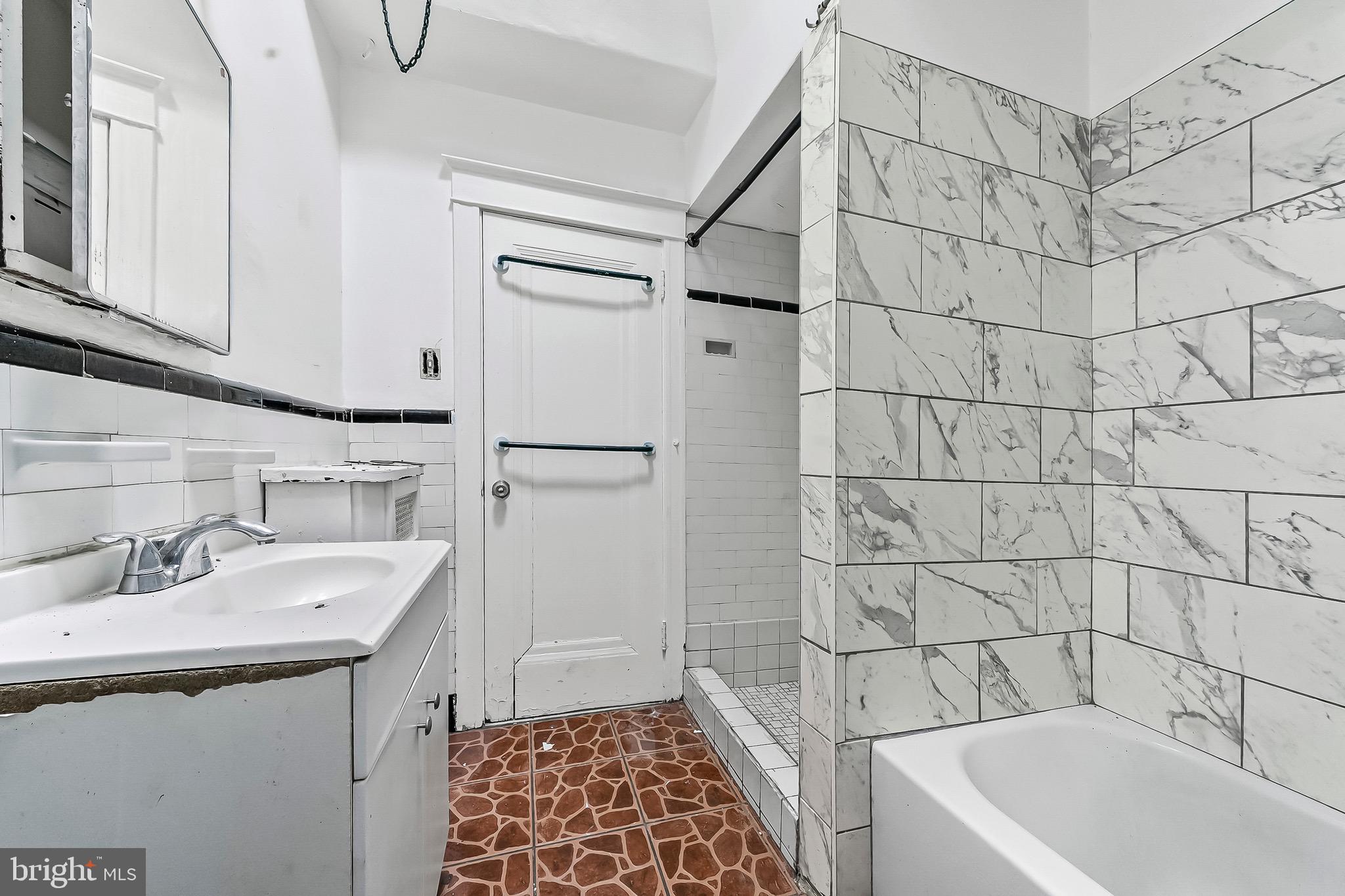 7269 Walnut Street Upper Darby, PA 19082 - Photo 4 of 17 a bathroom with a sink a toilet and shower