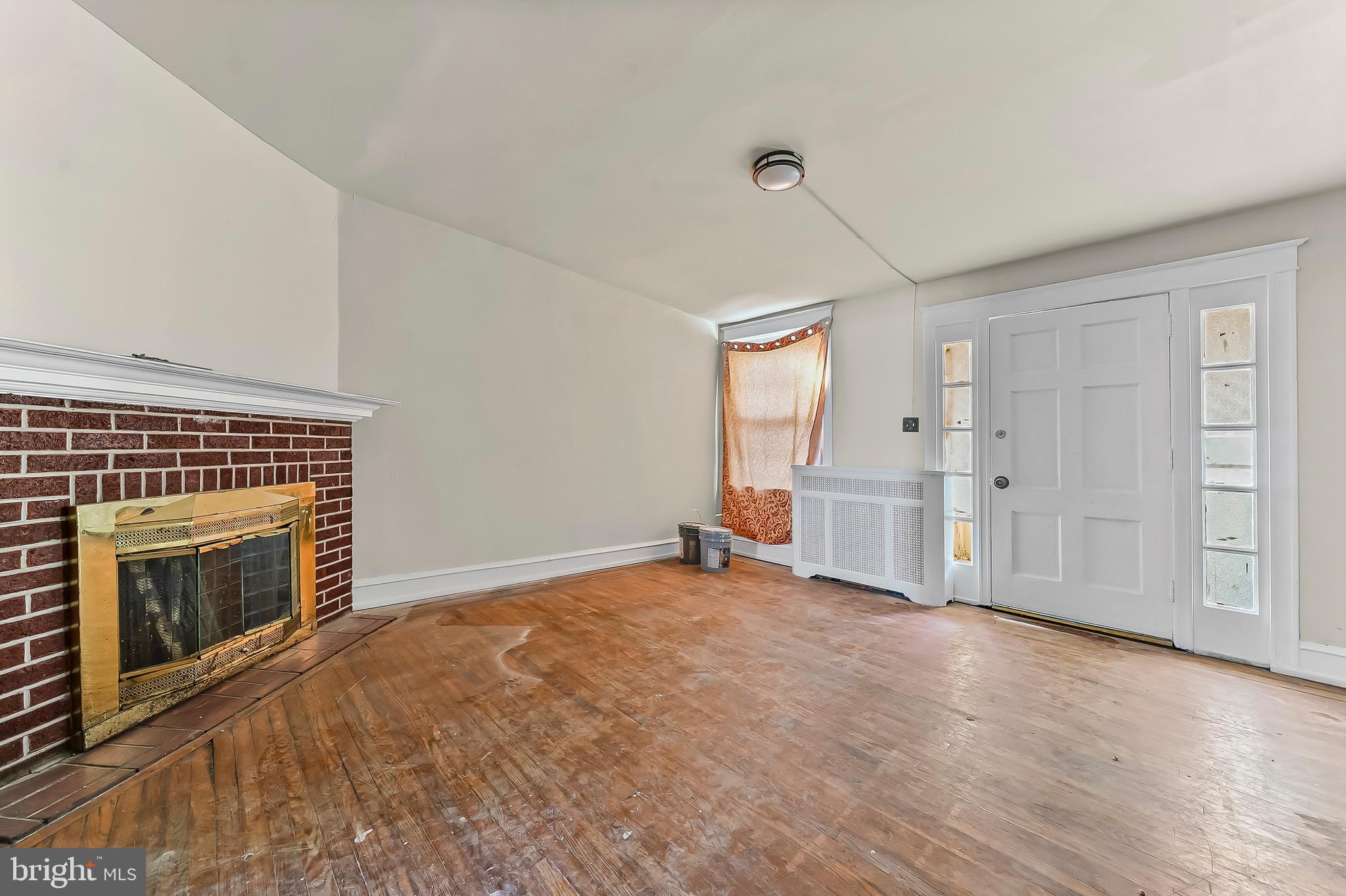 7269 Walnut Street Upper Darby, PA 19082 - Photo 9 of 17 wooden floor fireplace and windows in an empty room