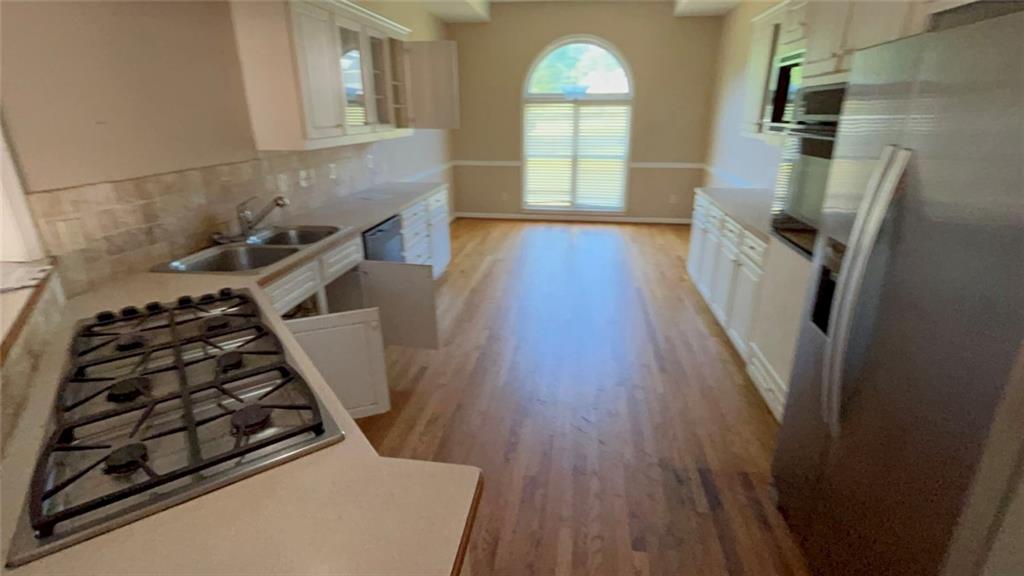 1730 Dane Terrace Dacula, GA 30019 - Photo 2 of 5 wooden floor in a kitchen next to a window
