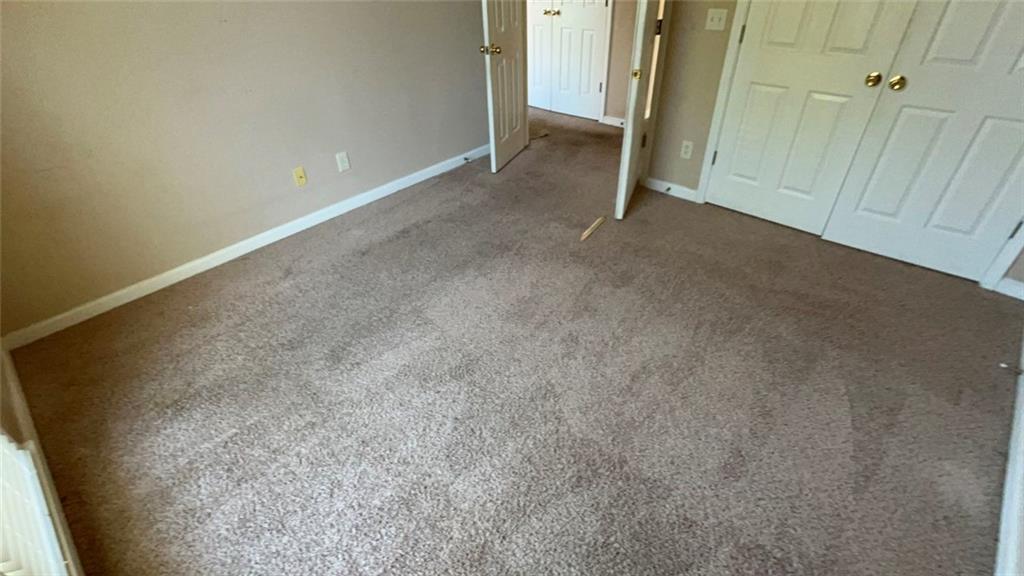 1730 Dane Terrace Dacula, GA 30019 - Photo 4 of 5 an empty room with a bench