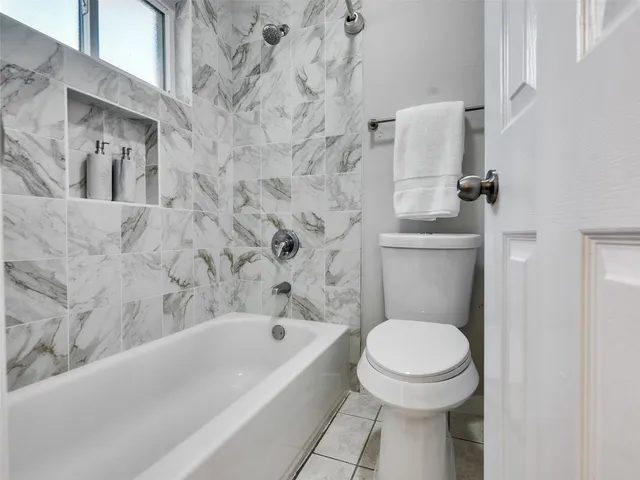 a bathroom with a toilet and a bathtub