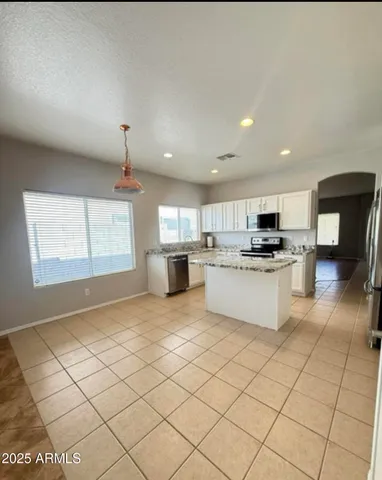 a kitchen with cabinets and white appliances