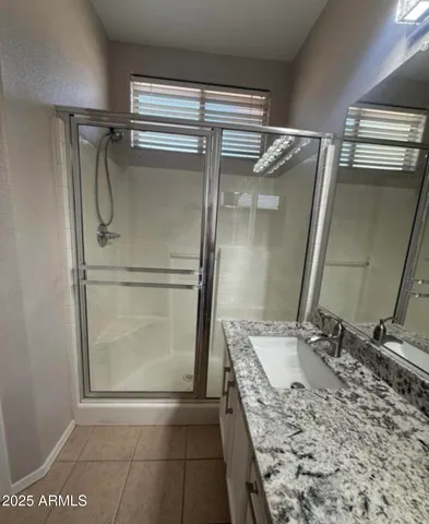 a view of a backyard with plants and large trees