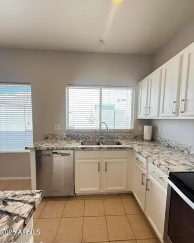 a kitchen with stainless steel appliances granite countertop a stove a sink and a granite counter tops