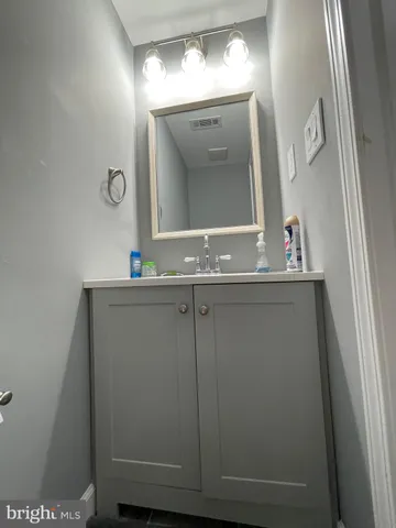 a bathroom with a sink a mirror and a vanity