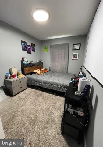 a bedroom with furniture and a wooden floor