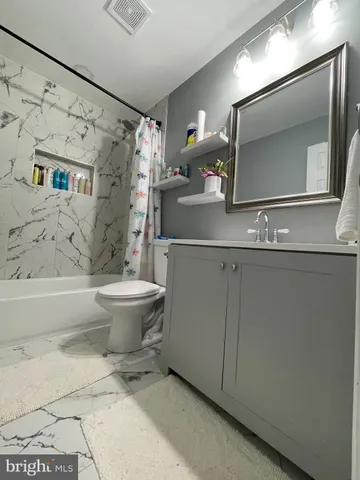 a bathroom with a sink toilet and mirror