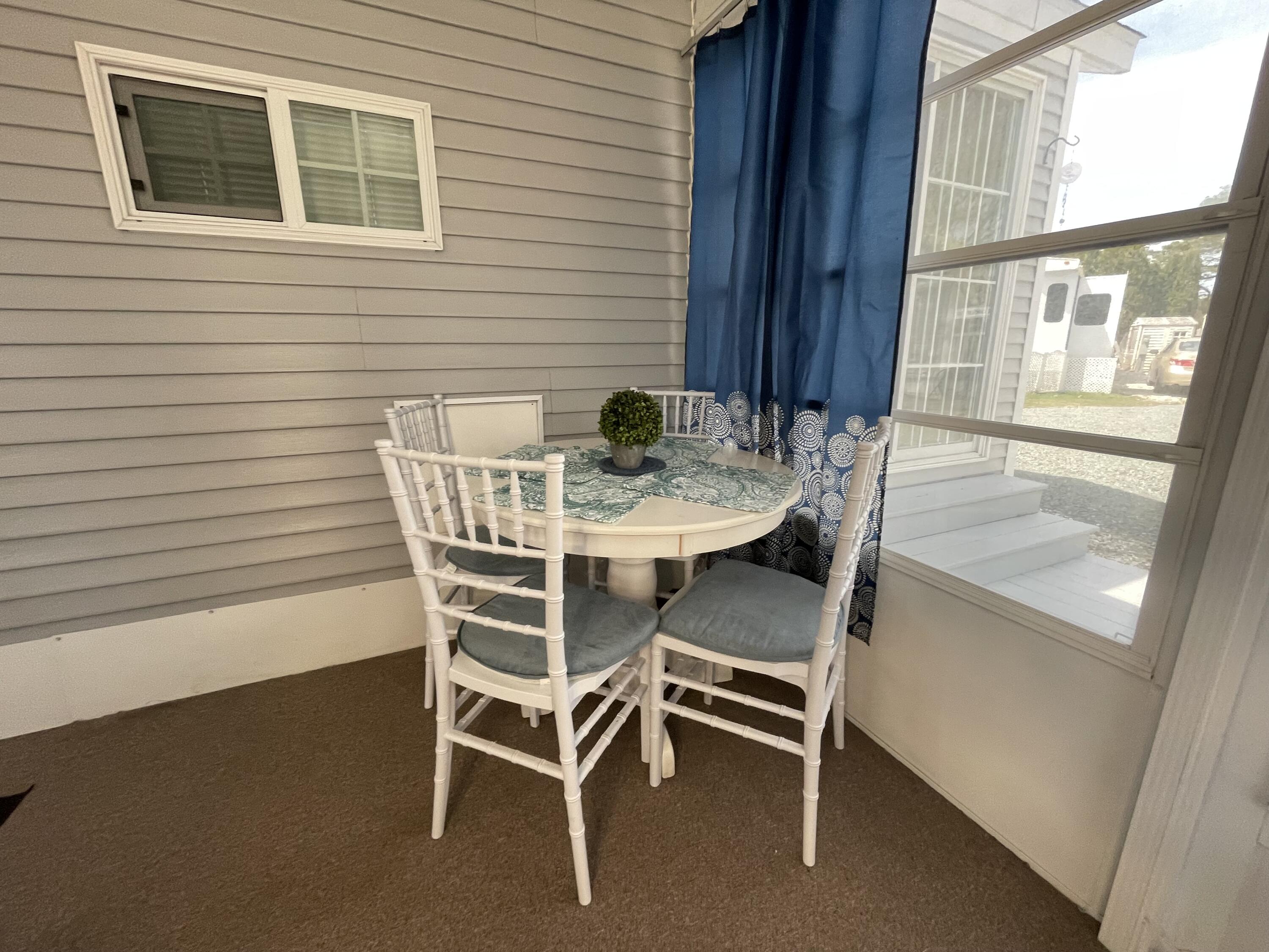 184 Old Wharf Road, Unit G05 Dennis Port, MA 02639 - Photo 11 of 17 a dining room with furniture and window