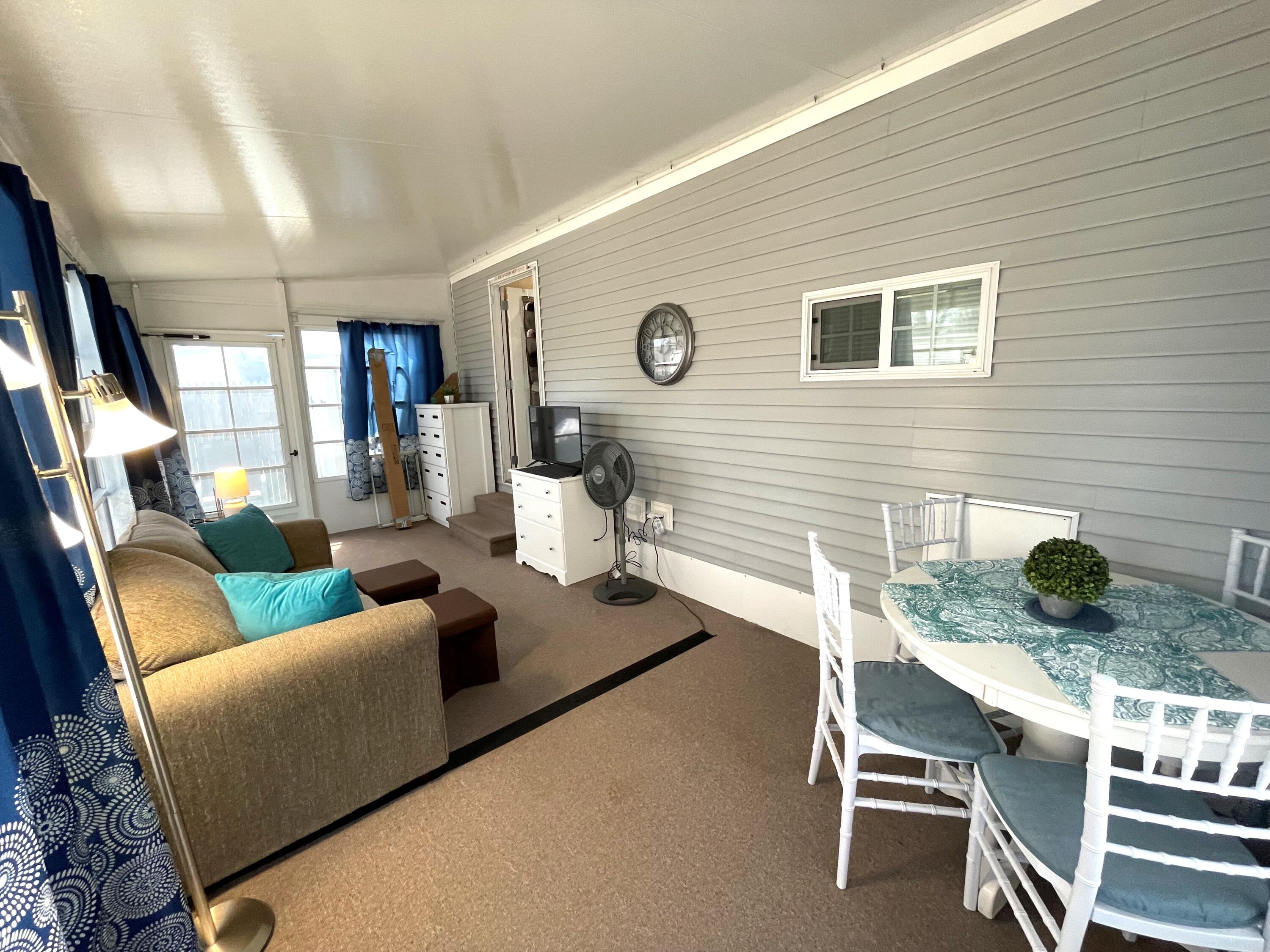 184 Old Wharf Road, Unit G05 Dennis Port, MA 02639 - Photo 12 of 17 a living room with furniture and a table