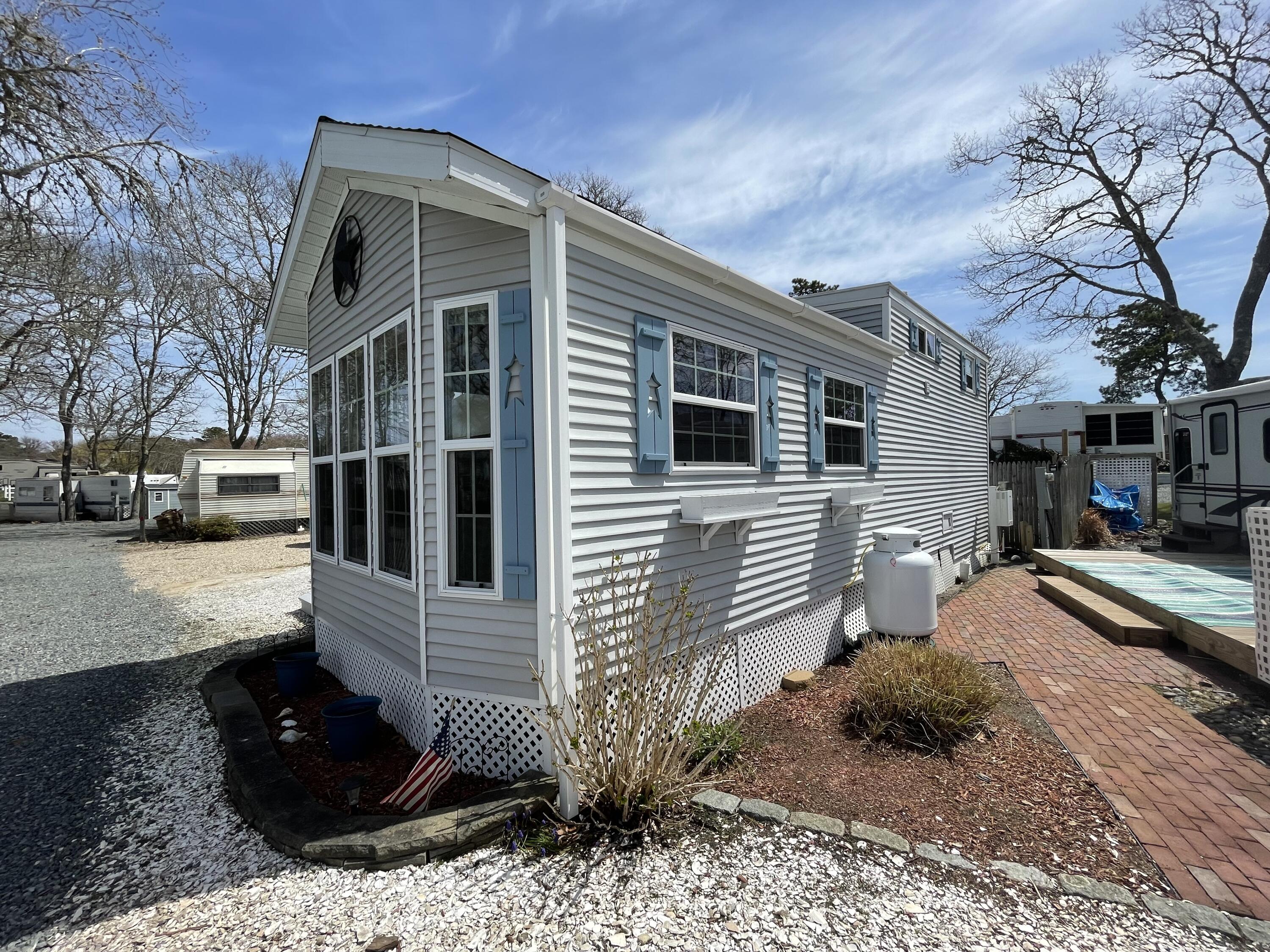 184 Old Wharf Road, Unit G05 Dennis Port, MA 02639 - Photo 13 of 17 a view of a house with a yard