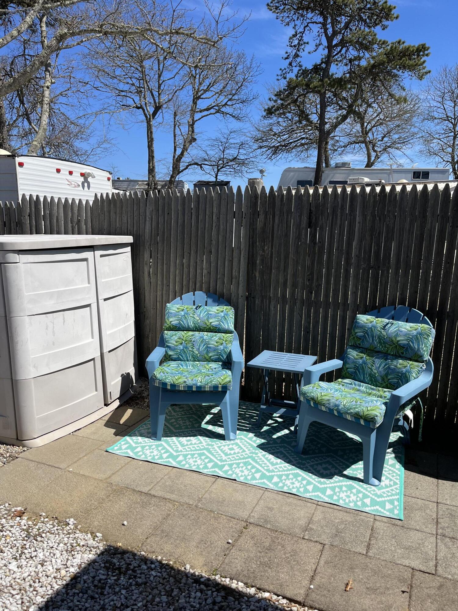 184 Old Wharf Road, Unit G05 Dennis Port, MA 02639 - Photo 14 of 17 a backyard of a house with barbeque oven a barbeque oven and outdoor seating