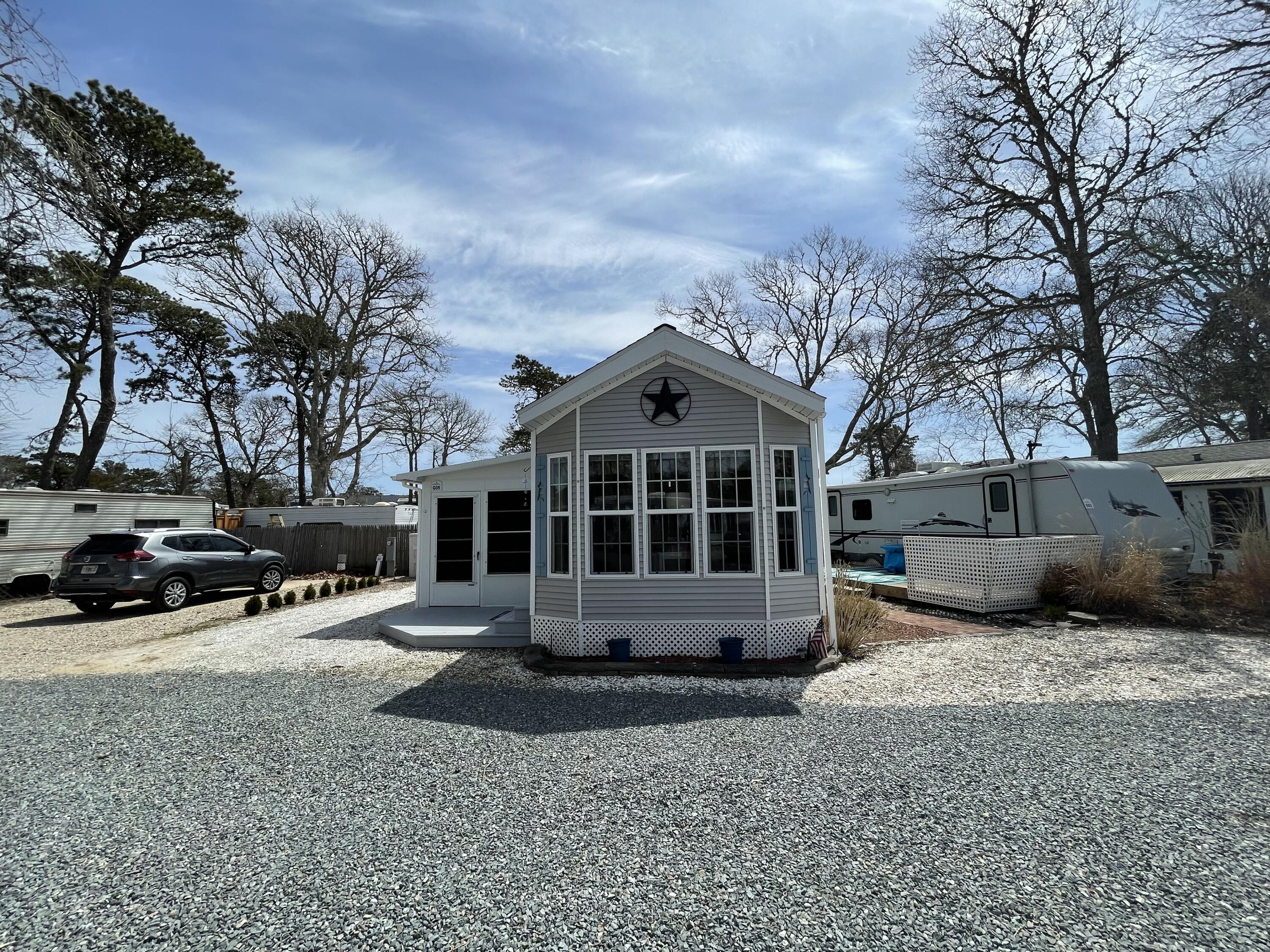 184 Old Wharf Road, Unit G05 Dennis Port, MA 02639 - Photo 2 of 17 a view of a house with a yard covered in snow