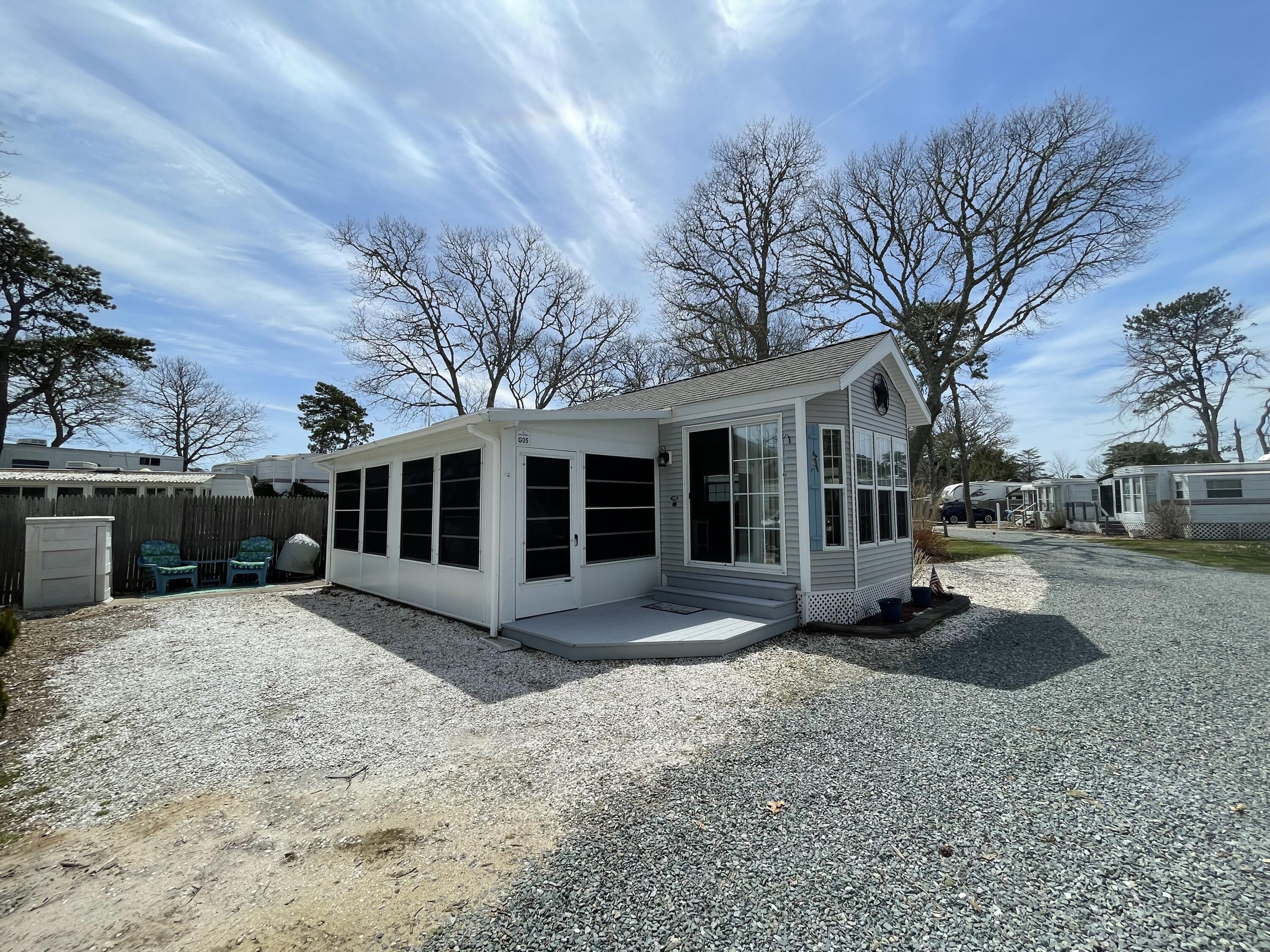 184 Old Wharf Road, Unit G05 Dennis Port, MA 02639 - Photo 3 of 17 a view of a house with a yard and large tree