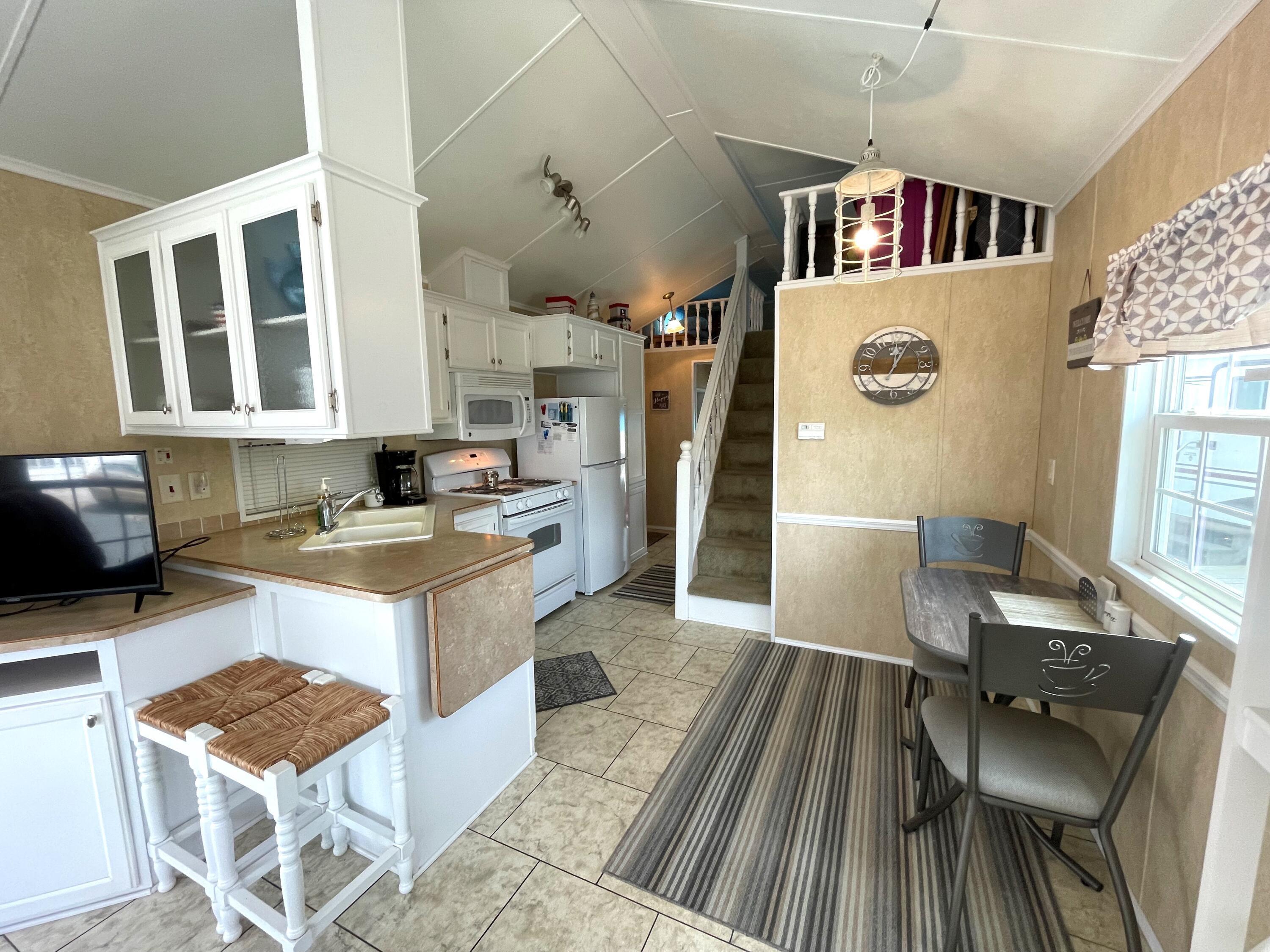 184 Old Wharf Road, Unit G05 Dennis Port, MA 02639 - Photo 4 of 17 a kitchen with stainless steel appliances granite countertop a stove and a refrigerator