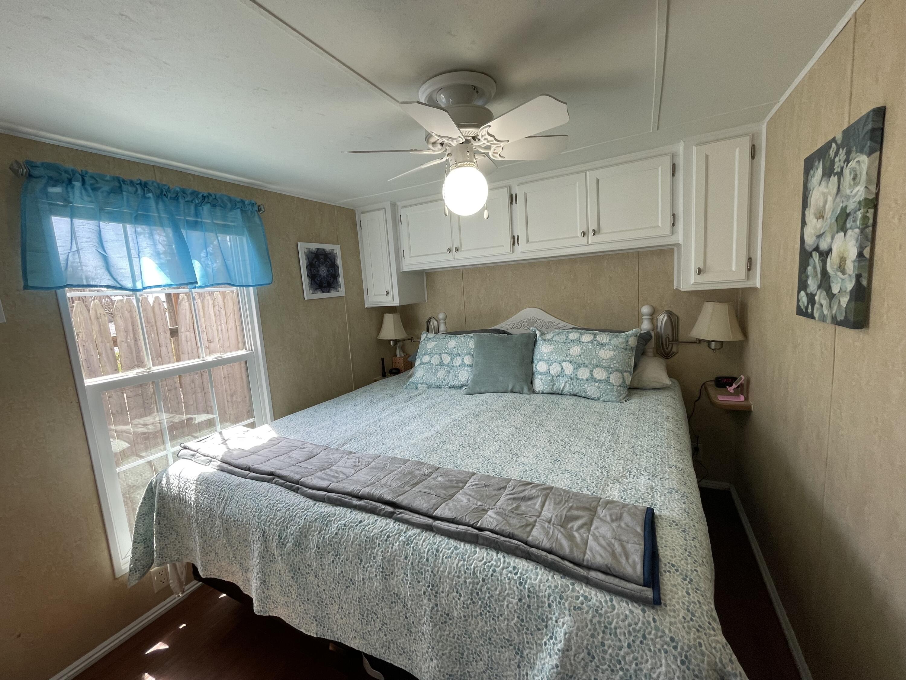 184 Old Wharf Road, Unit G05 Dennis Port, MA 02639 - Photo 6 of 17 a bedroom with a bed and a chandelier