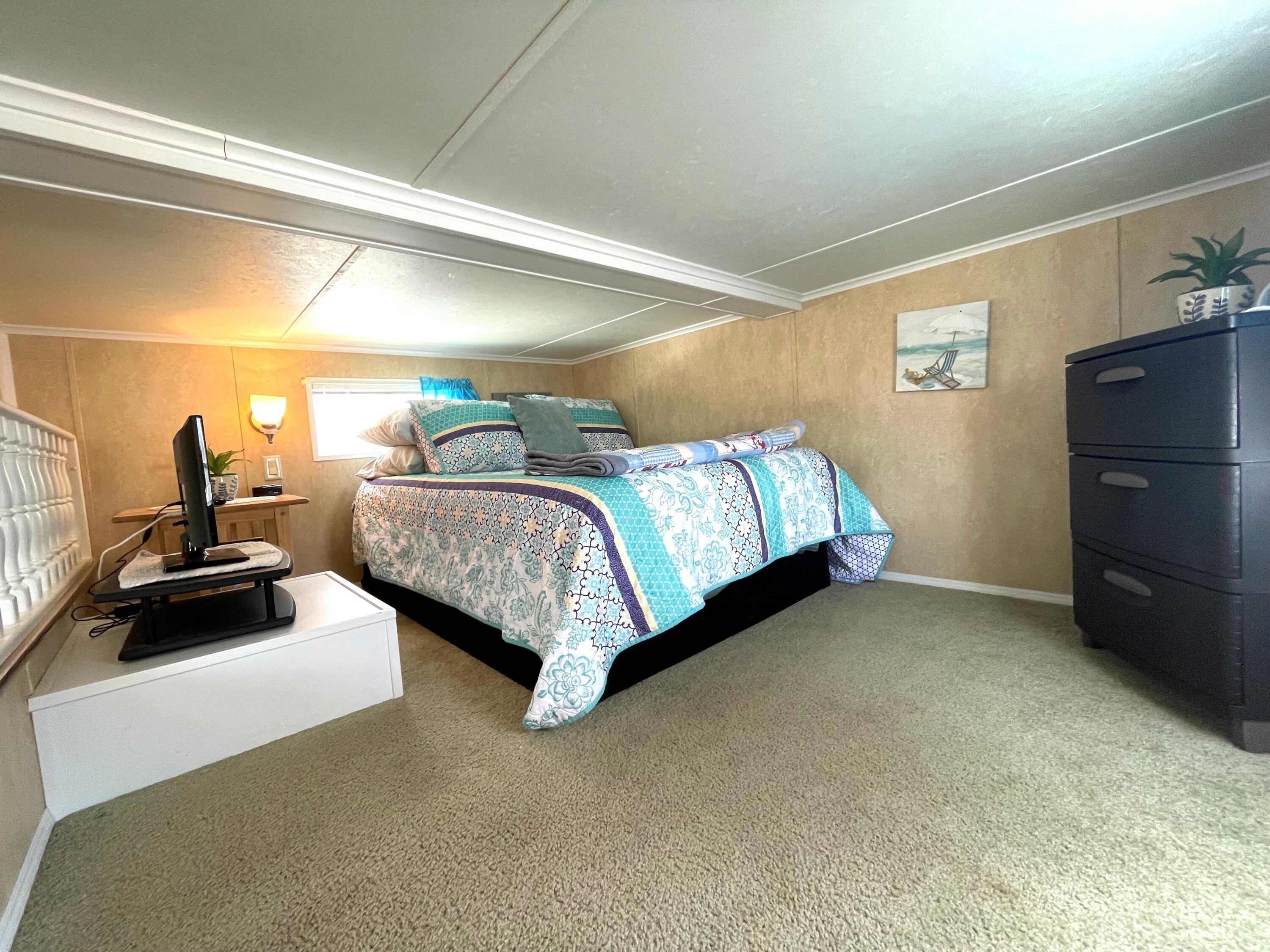 184 Old Wharf Road, Unit G05 Dennis Port, MA 02639 - Photo 8 of 17 a bedroom with a bed and a walk in closet