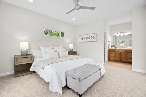 a spacious bedroom with a bed and a cabinets