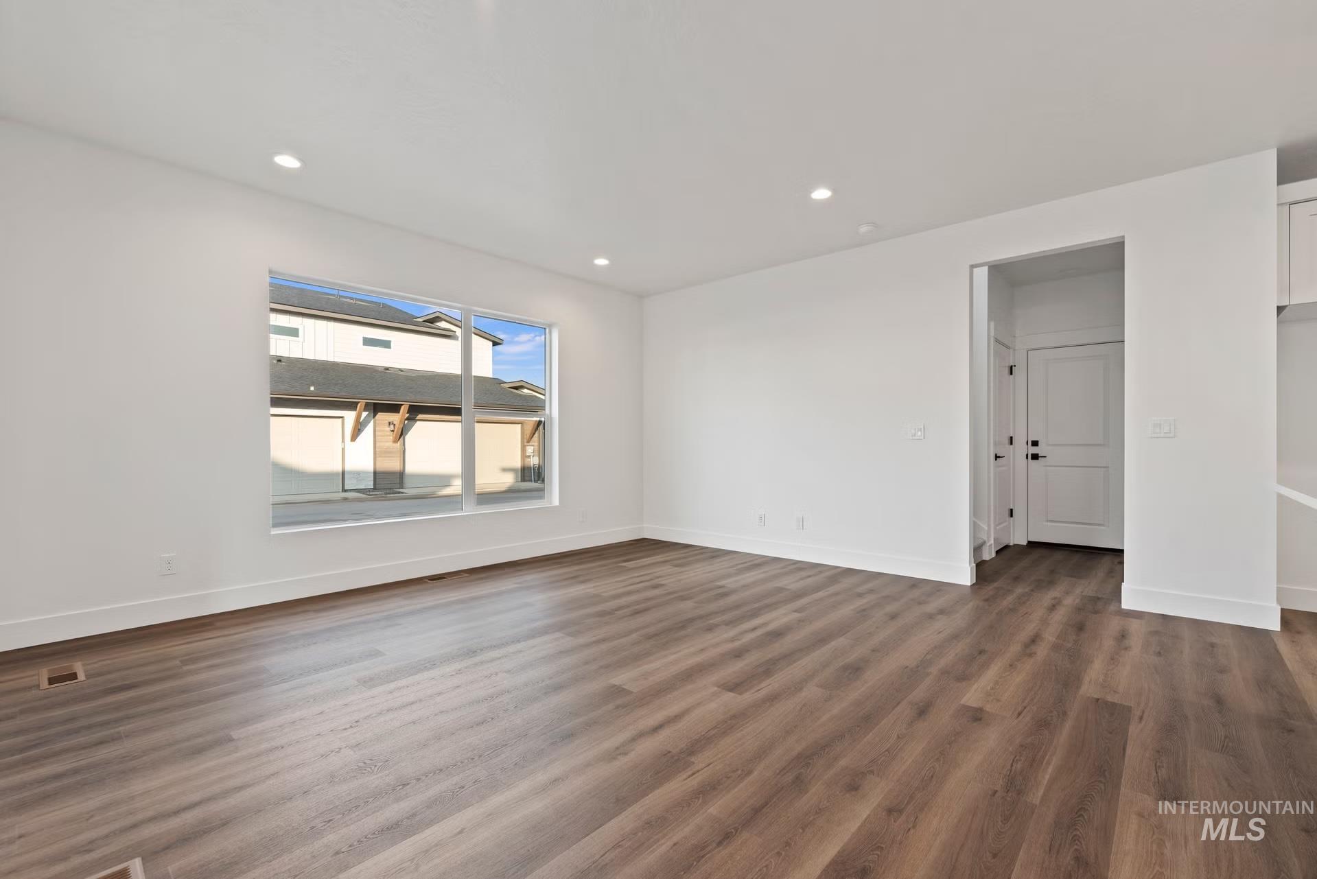 748 South Calhoun Place Star, ID 83669 - Photo 11 of 32 Empty room featuring recessed lighting and dark wood-style floors