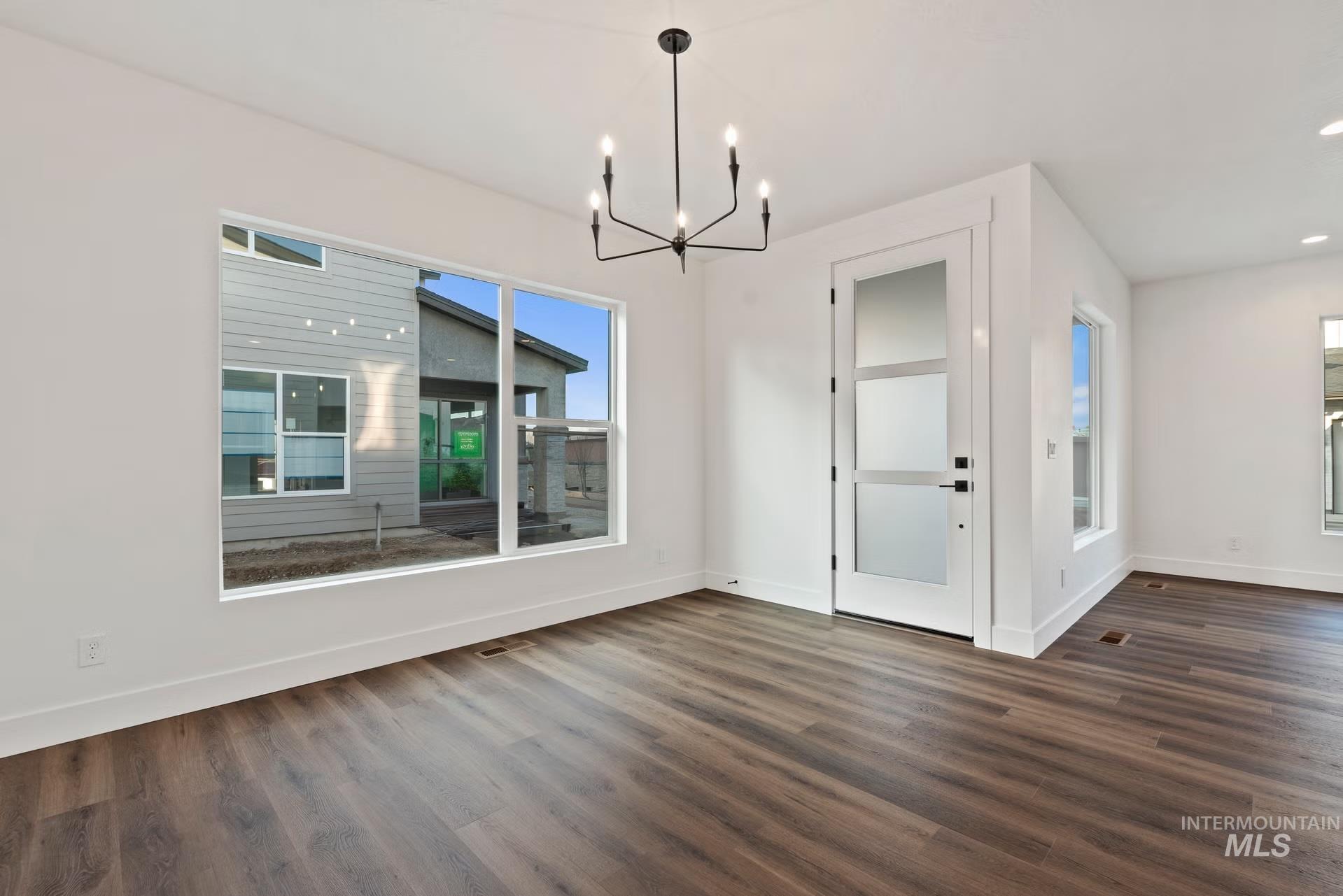 748 South Calhoun Place Star, ID 83669 - Photo 14 of 32 Unfurnished dining area with suspended lighting and dark wood-style floors