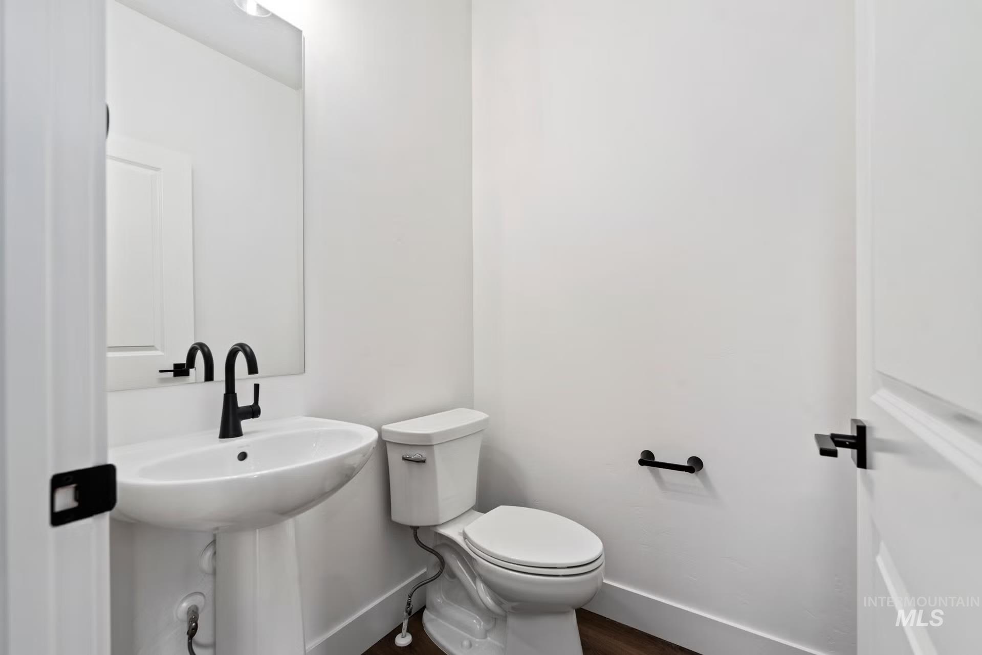 748 South Calhoun Place Star, ID 83669 - Photo 17 of 32 Half bath featuring toilet and dark wood finished floors