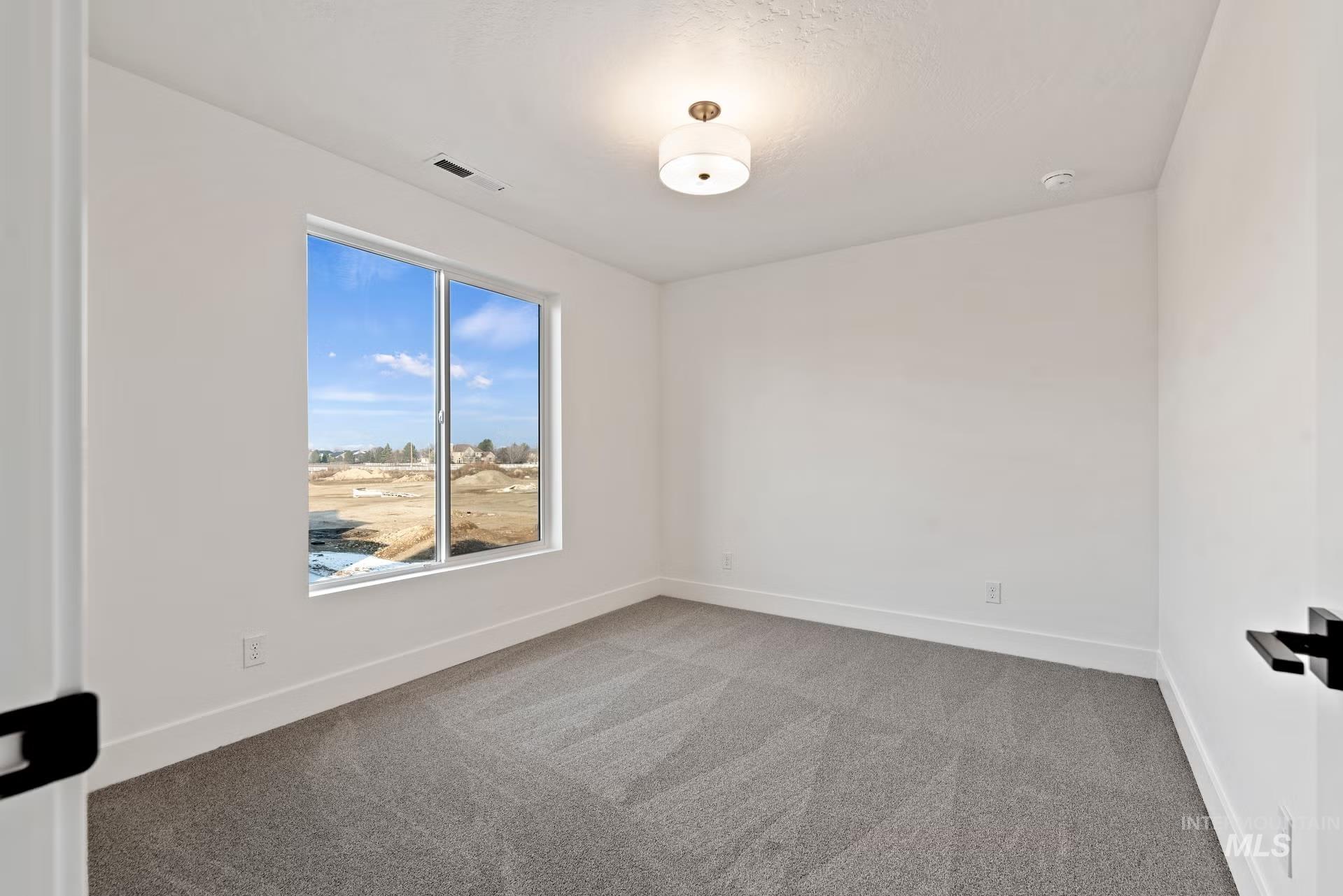 748 South Calhoun Place Star, ID 83669 - Photo 21 of 32 Empty room with light colored carpet and baseboards