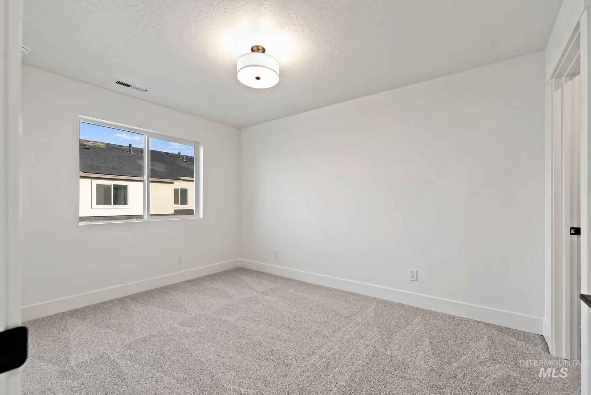 748 South Calhoun Place Star, ID 83669 - Photo 22 of 32 Spare room with light carpet and baseboards
